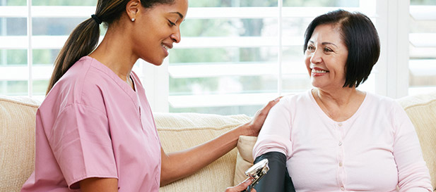 nurse taking blood pressure of resident